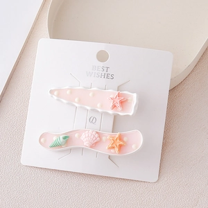 Détails de barrettes à cheveux thème océan avec étoiles de mer sur carte de présentation