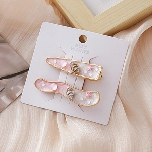 Barrettes marines avec étoiles de mer, coquillages, résine rose et perles