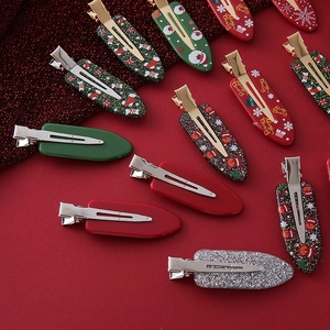 Detailed view of festive Christmas hair clips with Santa Claus and reindeer designs