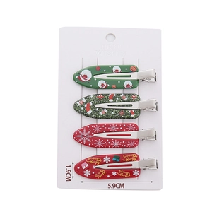 Set of four Christmas-themed non-marking hair clips with Santa and reindeer designs