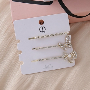 Three-piece set of elegant gold rhinestone hairpins with butterfly and pearl designs