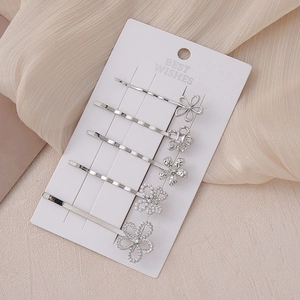 5-piece silver floral hair clip set with rhinestones and pearls on display card