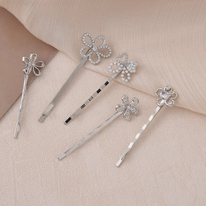 Detail view of 5-piece floral hair clip set with rhinestones and pearls in silver
