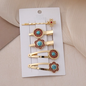 Detailed set of 5 vintage alloy hair clips with ethnic patterns on display card