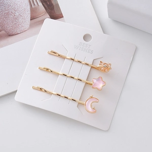 Set di fermagli per capelli dorati con luna e cuore rosa e strass su carta