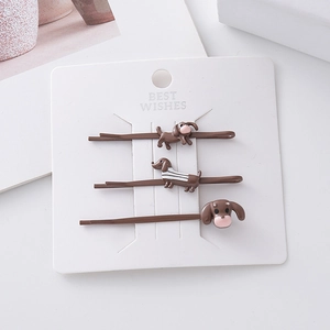 Three-piece dachshund hair clip set in brown with striped sweater dog design