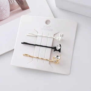 Three-piece set of cartoon cat hair clips in white, black and gold with rhinestones