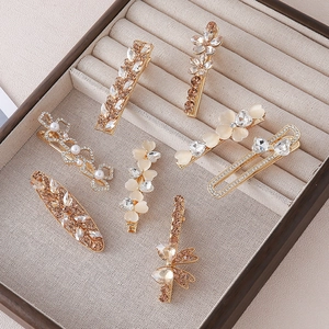 Elegant 7-piece gold hair clip set with pearls, rhinestones and floral heart designs