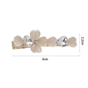 Elegant gold hair clip featuring yellow cat eye hearts and sparkling crystal floral patterns