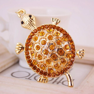 Porte-clés tortue dorée avec cristaux ambrés et yeux en pierres noires brillantes