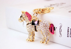 Close-up of golden horse keychain with sparkling rhinestones and enamel details