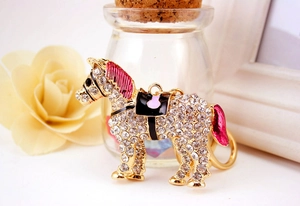 Detailed view of horse keychain with white rhinestones and pink enamel on gold alloy