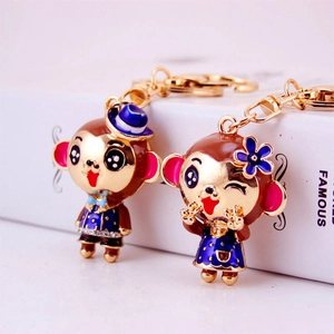 Cute golden metal monkey zodiac keychain pair with enamel and rhinestone accents