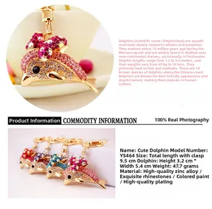 Macro detail of rhinestone-encrusted dolphin keychain with size measurements and color options