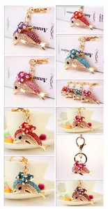 Detail shots of colorful rhinestone dolphin keychains with gold-plated lobster clasps