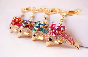 Macro shot of dolphin keychain with colorful rhinestones and gold lobster clasp