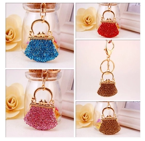 Detailed macro view of crystal rhinestone handbag keychains in four vibrant colors