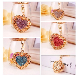 Close-up detail of heart-shaped rhinestone keychains in multiple colors with gold plating