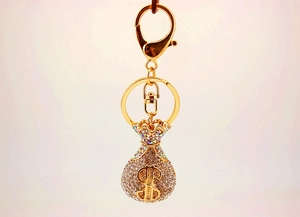 Detail of crystal encrusted money bag keychain with gold plating and dollar sign