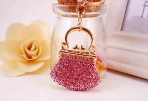 Detailed macro view of pink rhinestone-studded handbag keychain with gold-plated finish