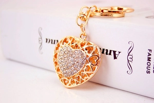 Detailed view of heart-shaped keychain with sparkling rhinestones and golden finish