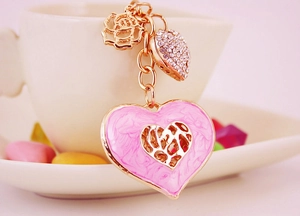 Detail of pink heart keychain with gold marble oil drip and sparkling rhinestone rose charm