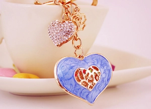 Detail of blue marble enamel heart keychain with rhinestones and golden hardware