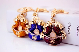 Detailed view of three koi fish keychains with enamel finish and gold Fu characters