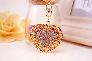 Detail of heart keychain with sparkling rhinestones and elegant gold plating