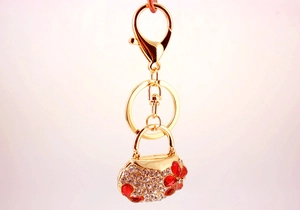 Macro detail of handbag keychain with sparkling rhinestones and gold-plated finish