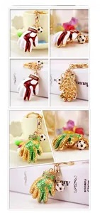 Macro detail of enamel football goalkeeper glove keychain with mini soccer ball charm