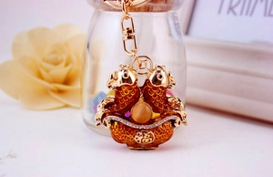 Detailed close-up of golden carp keychain with red enamel and lucky fortune symbol