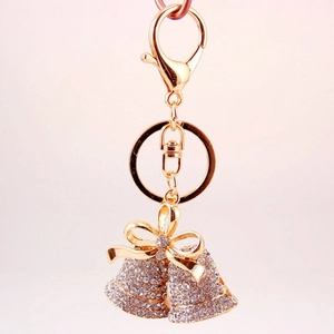 Golden Christmas bell keychain with sparkling rhinestones and a delicate bow pendant