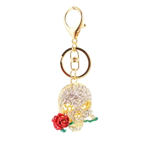Porte-clés crâne doré avec strass brillants et breloque en forme de rose rouge