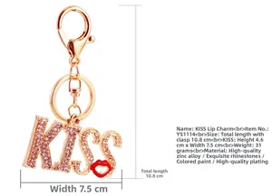 Detailed view of the sparkling KISS rhinestones and red lip charm on the golden keychain