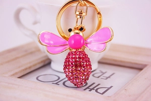 Close-up of pink crystal bee keychain with gold plating and spring lobster clasp