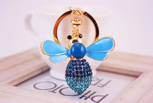 Detailed close-up of crystal bee keychain with blue enamel wings and gold alloy lobster clasp