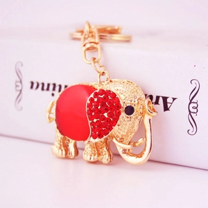 Golden elephant keychain with a large red center stone and crystal-embellished ears