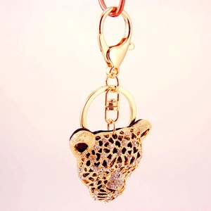 Porte-clés tête de léopard dorée avec strass scintillants et fermoir mousqueton