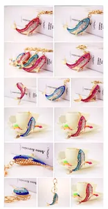 Detail showing various colors of rhinestone shark keychains with gold zinc alloy lobster clasps