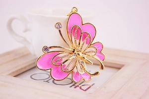 Macro view of butterfly pendant featuring pink enamel wings and sparkling rhinestones