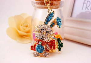 Détail d'un porte-clés lapin mignon orné de strass bleus et blancs et d'une petite carotte