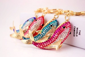 Detailed view of four colorful shark keychains with rhinestones and gold alloy rings