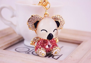Close-up of pink rhinestone koala keychain with star gem on a ceramic background