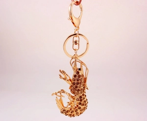 Macro view of rose gold lobster keychain featuring brown rhinestones and lobster clasp