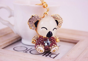 Detail of koala keychain with purple rhinestones and blue star gemstone on a gold base