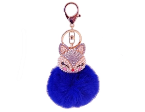 Detail of fox-shaped keychain with rhinestones, pearls and a navy blue fur pompom