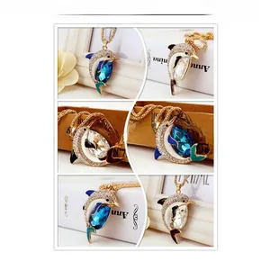 Macro details of dolphin crystal pendant necklace with sparkling rhinestones in blue and white