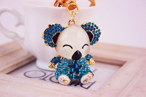 Close-up of cute koala keychain with blue rhinestones and gold metal frame finish