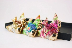 Gros plan de porte-clés poissons tropicaux sertis de strass en or, bleu et rose